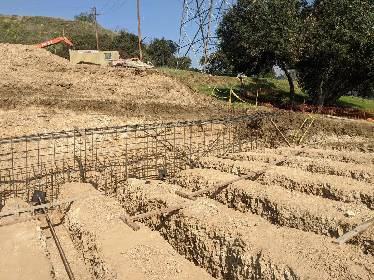 Excavated hillside with reinforcing steel along the cut