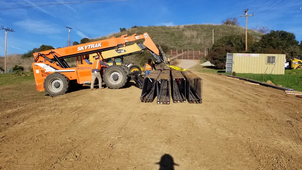 Construction equipment on a graded hillside work area
