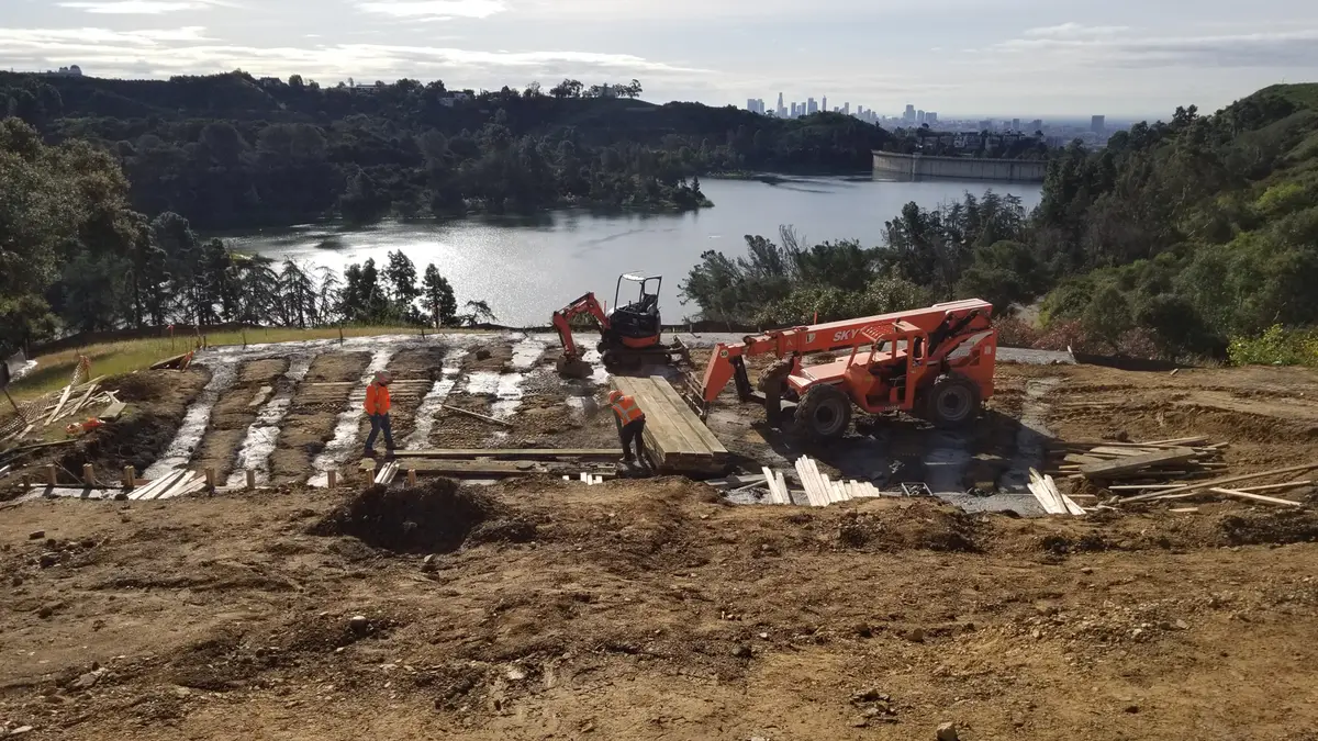 Excavation and construction equipment on a hillside above Hollywood Reservoir